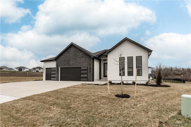 view of front of home featuring a front lawn and a garage