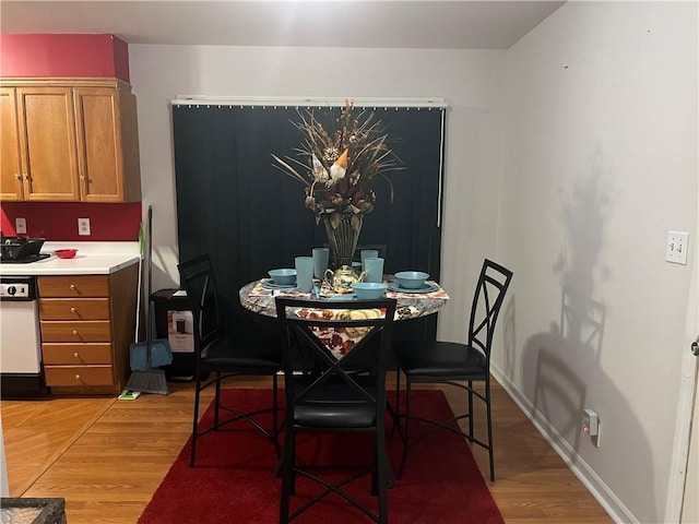 dining space with light hardwood / wood-style flooring