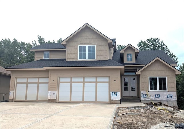 14709 Fairway St, Leawood, KS 66224 - view of front of house featuring french doors, concrete driveway, an attached garage, and a shingled roof