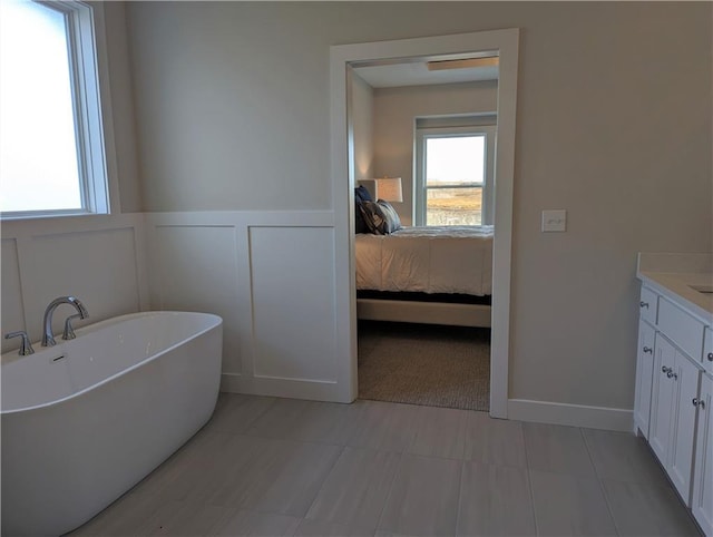 14709 Fairway St, Leawood, KS 66224 - full bathroom with ensuite bathroom, a soaking tub, vanity, a wainscoted wall, and a decorative wall