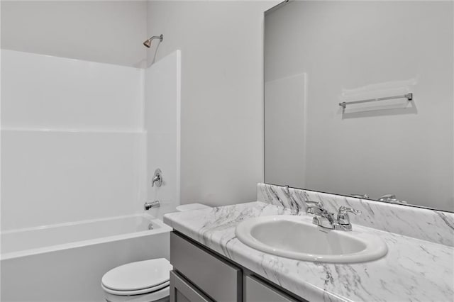 full bathroom featuring tub / shower combination, vanity, and toilet