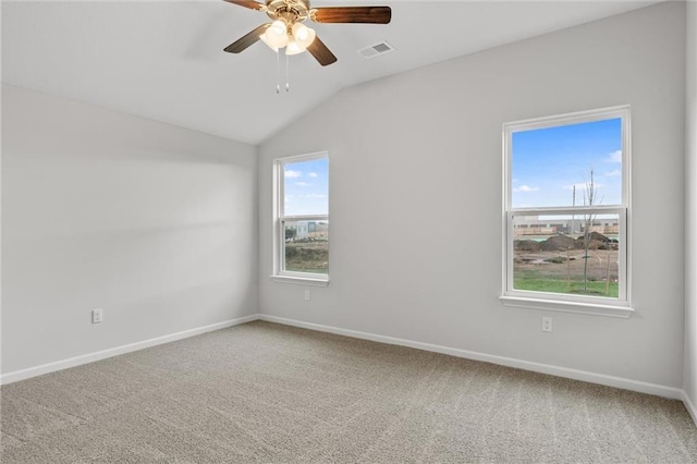 carpeted empty room featuring ceiling fan and lofted ceiling