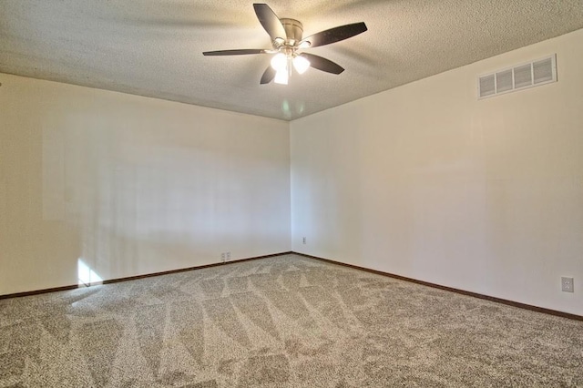 carpeted spare room featuring ceiling fan and a textured ceiling