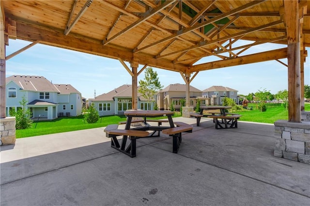 surrounding community with a gazebo, a patio, and a lawn