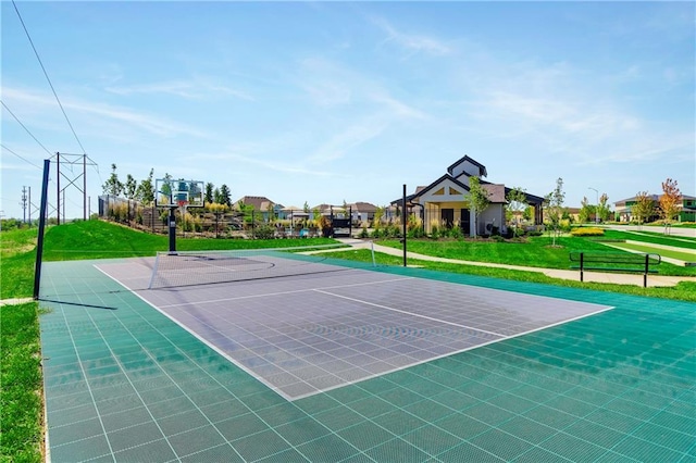 view of sport court with tennis court and a yard