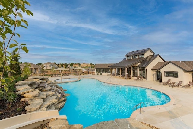 view of swimming pool featuring a patio area