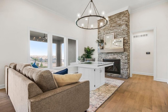 4102 W 158th Ter, Overland Park, KS 66224 - living room featuring a chandelier, a fireplace, baseboards, ornamental molding, and light wood-style flooring