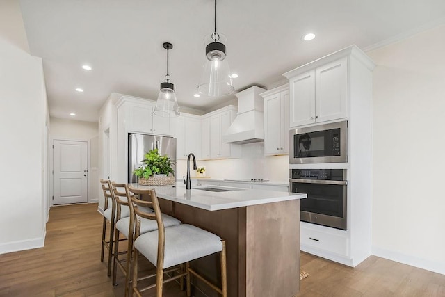 4102 W 158th Ter, Overland Park, KS 66224 - kitchen with appliances with stainless steel finishes, custom exhaust hood, recessed lighting, wood finished floors, and baseboards