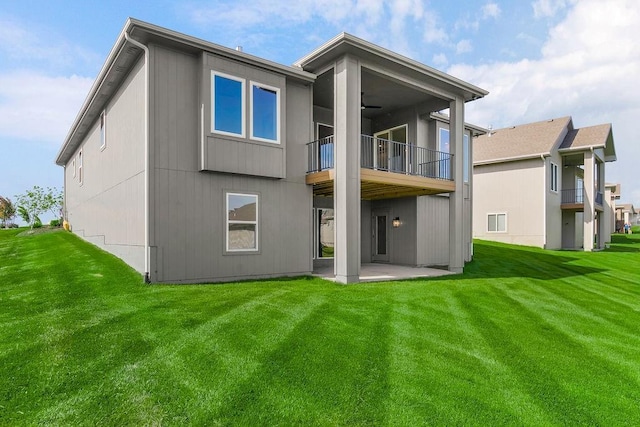 4102 W 158th Ter, Overland Park, KS 66224 - back of house featuring a balcony, a patio area, a ceiling fan, and a yard