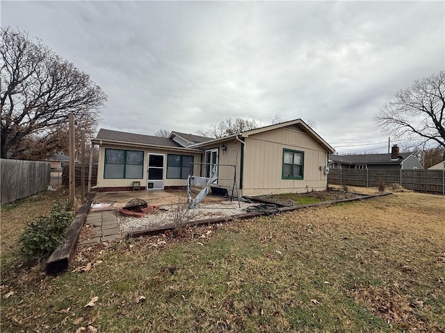 rear view of house with a lawn