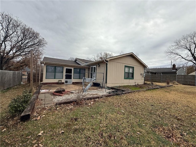 2123 N 8th St, Independence, KS 67301 - rear view of house with a fire pit, a fenced backyard, and a patio