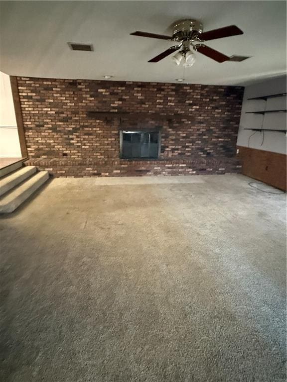 2123 N 8th St, Independence, KS 67301 - unfurnished living room featuring brick wall, carpet flooring, and ceiling fan