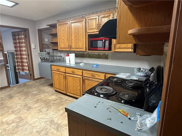 2123 N 8th St, Independence, KS 67301 - kitchen featuring open shelves, stainless steel microwave, range, brown cabinetry, and stone finish floors