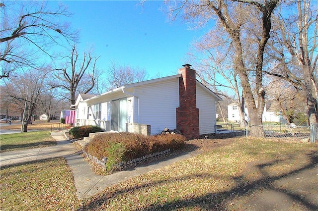 view of side of home with a yard