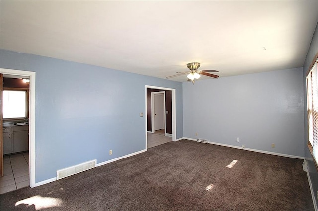 carpeted empty room with ceiling fan