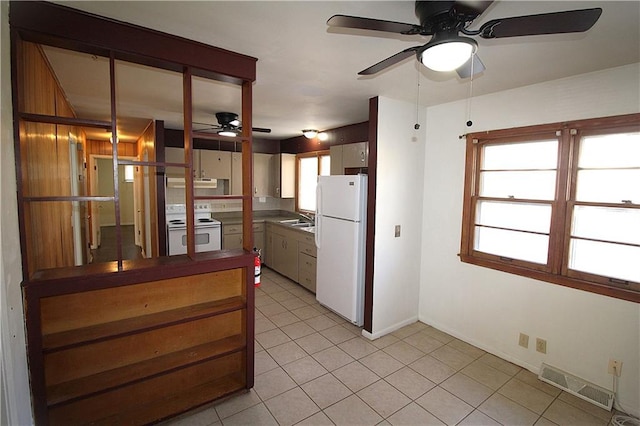 kitchen with white appliances, ventilation hood, a healthy amount of sunlight, and sink