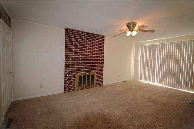 unfurnished living room featuring ceiling fan, carpet floors, and a brick fireplace