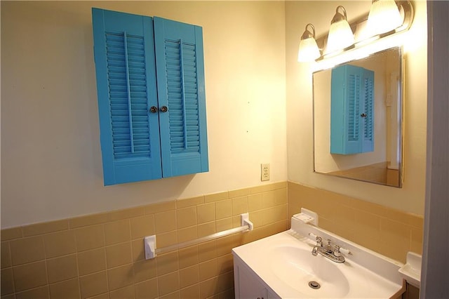 bathroom with vanity and tile walls