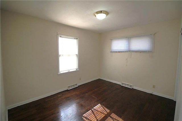 spare room featuring dark hardwood / wood-style floors