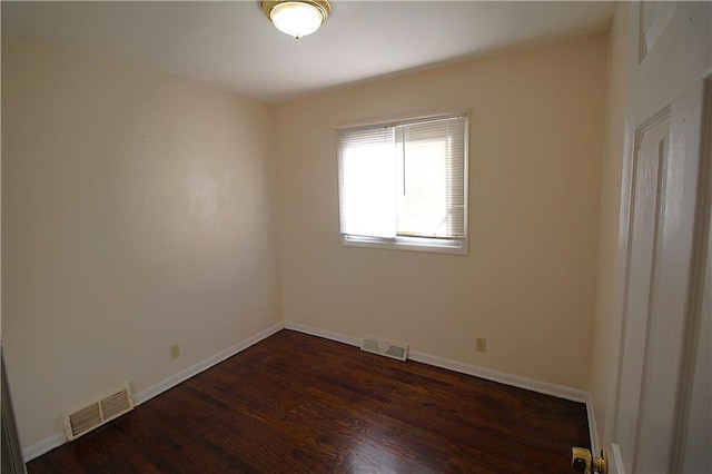 empty room featuring dark wood-type flooring