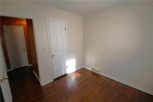 unfurnished room featuring dark hardwood / wood-style flooring