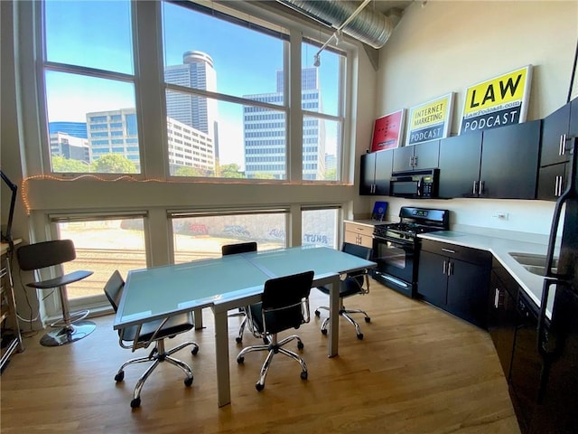 office featuring a high ceiling and light hardwood / wood-style flooring