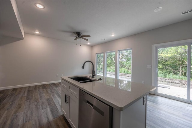 kitchen with stainless steel dishwasher, sink, hardwood / wood-style flooring, a center island with sink, and white cabinetry