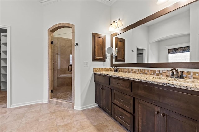 bathroom with tile patterned flooring, vanity, walk in shower, and crown molding