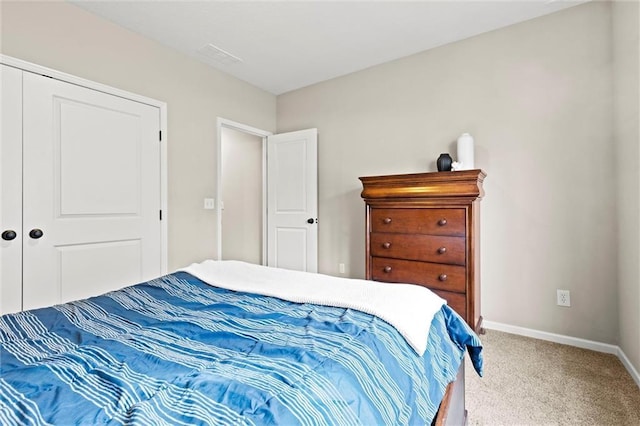 carpeted bedroom with a closet