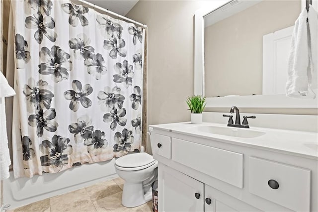 full bathroom with tile patterned flooring, vanity, toilet, and shower / bath combo with shower curtain