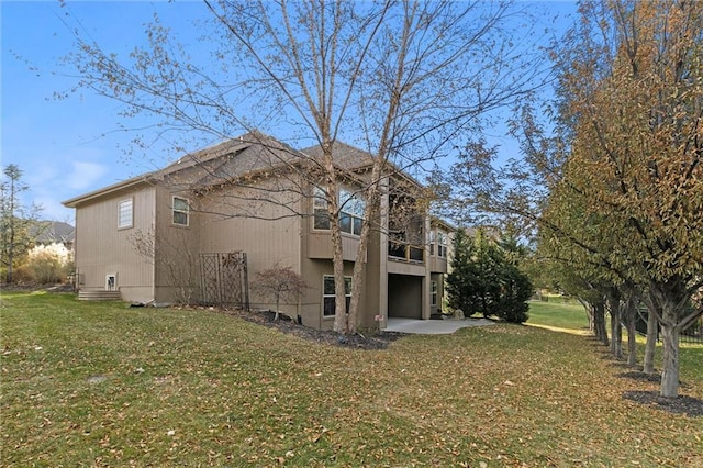 view of side of home featuring a lawn