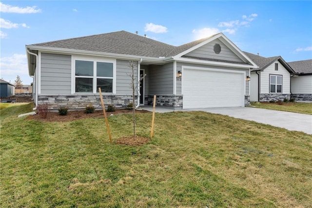 view of front facade with a garage and a front lawn