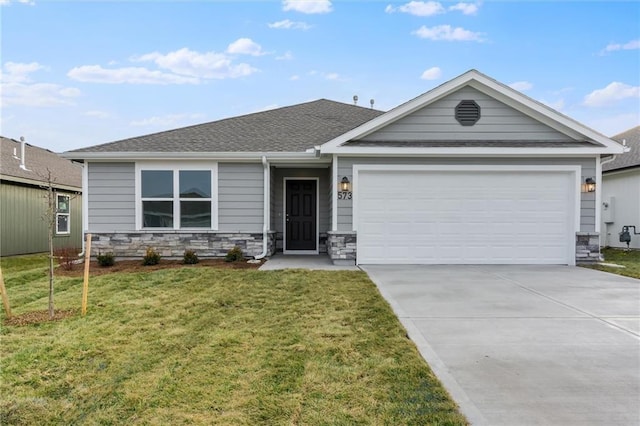 view of front of house with a front yard and a garage