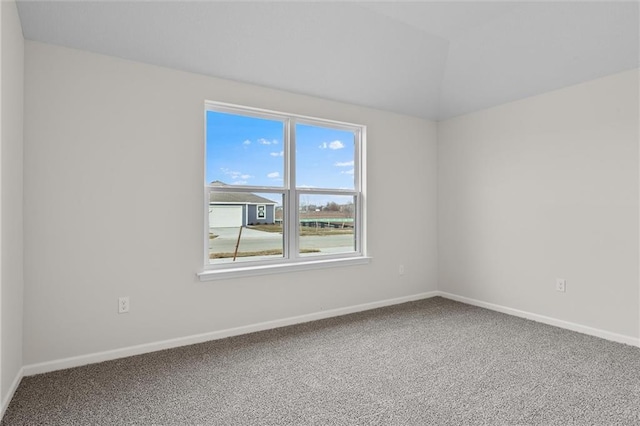 unfurnished room with carpet flooring and lofted ceiling