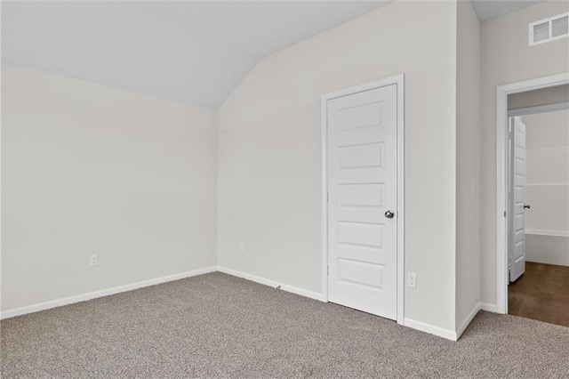 unfurnished bedroom featuring carpet floors and vaulted ceiling