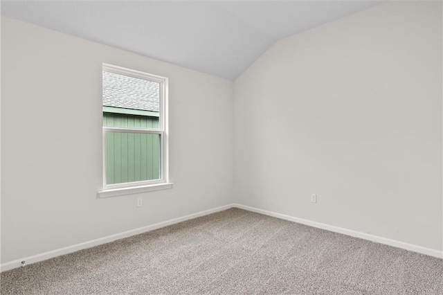 unfurnished room with carpet floors and vaulted ceiling