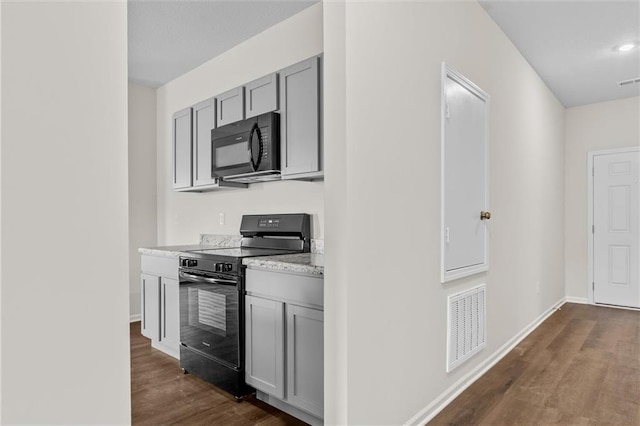 kitchen featuring gray cabinets, dark hardwood / wood-style floors, and black appliances