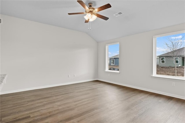 empty room featuring dark hardwood / wood-style flooring, ceiling fan, and lofted ceiling