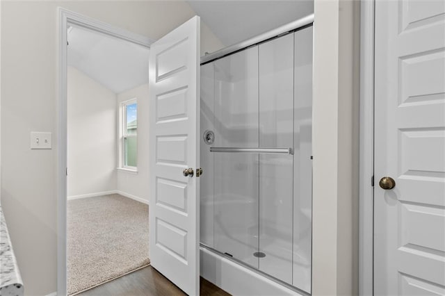 bathroom with hardwood / wood-style floors and an enclosed shower