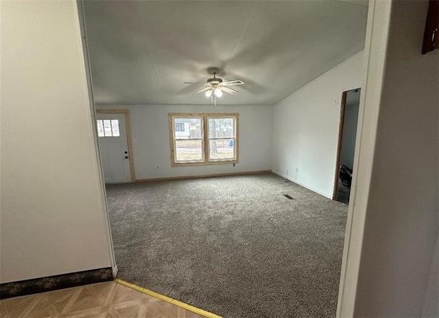 carpeted empty room featuring ceiling fan