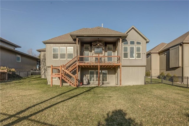 back of property featuring a lawn and a deck