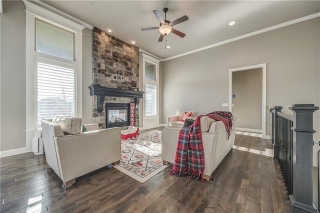 living room with dark hardwood / wood-style floors, a fireplace, crown molding, and ceiling fan