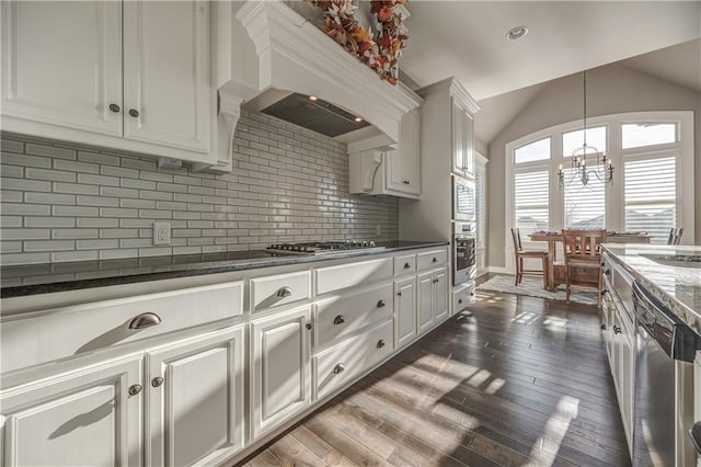 kitchen with dark hardwood / wood-style flooring, white cabinetry, premium range hood, and appliances with stainless steel finishes