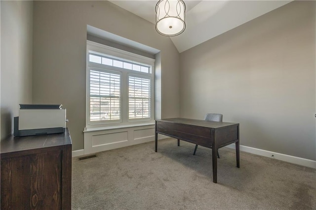 office area with light colored carpet and vaulted ceiling