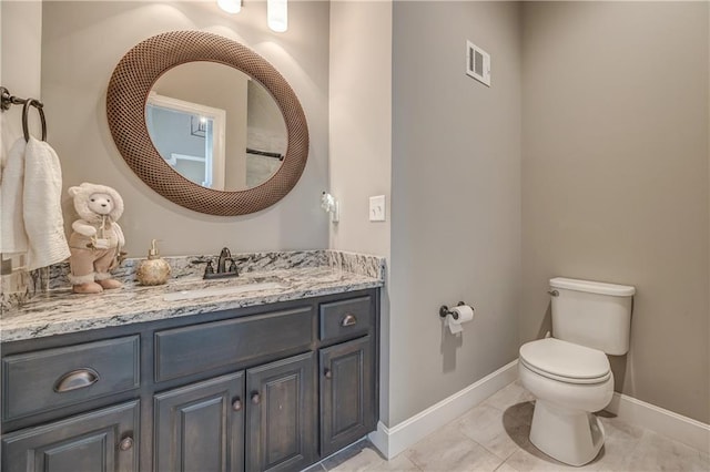 bathroom featuring tile patterned floors, vanity, and toilet