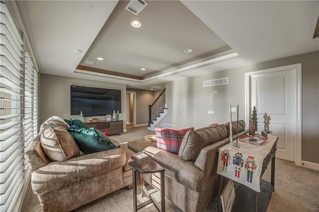 living room with carpet and a raised ceiling