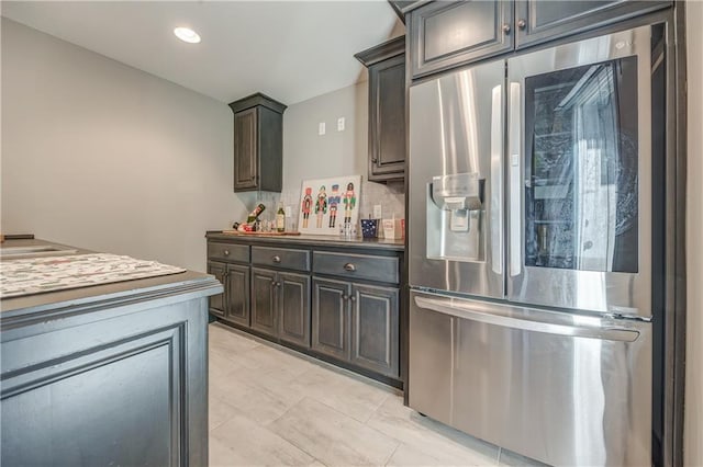 kitchen with dark brown cabinets and stainless steel refrigerator with ice dispenser