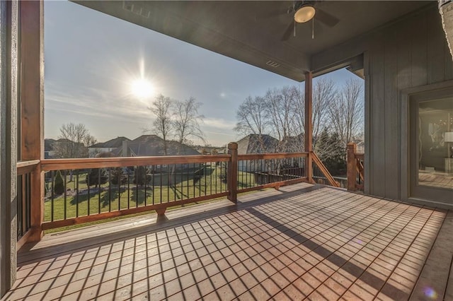 deck featuring ceiling fan and a yard