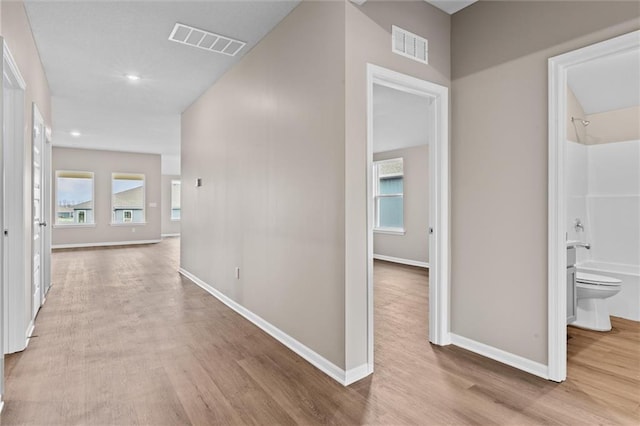 corridor featuring light hardwood / wood-style floors