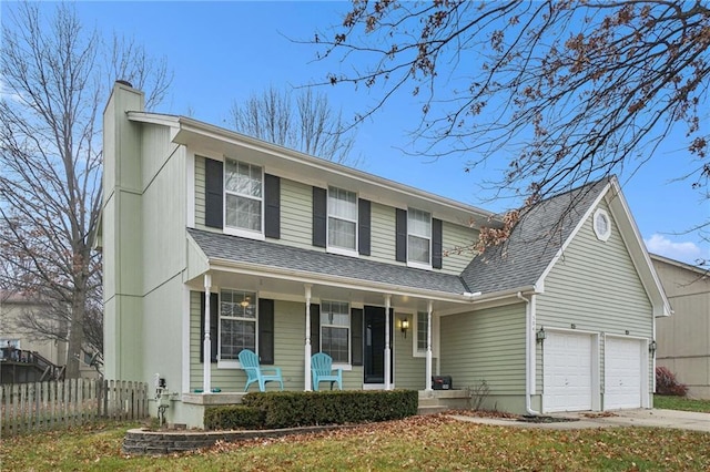 view of front of property featuring covered porch, a front yard, and a garage